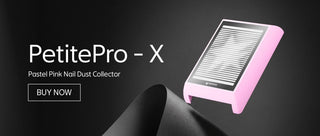 A pastel pink nail dust collector labeled PetitePro-X, shown floating above a dark abstract surface with promotional text on a black background.